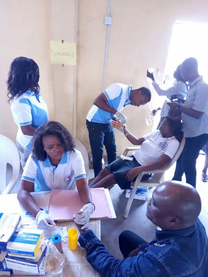 NHF staff conducting laboratory screening during a community outreach