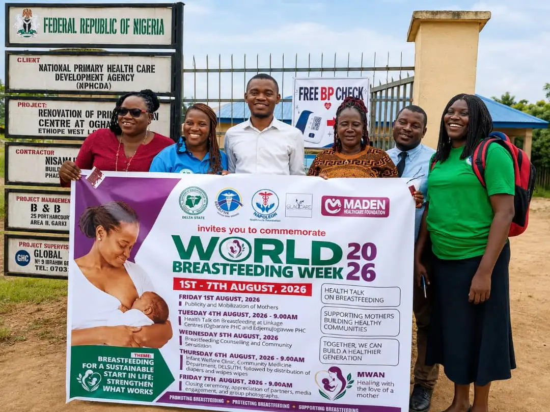 NHF and partner team with the World Breastfeeding Week 2026 banner at the health centre gate, Oghara
